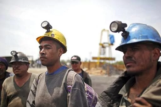 Miners helping in the rescue operation of fellow trapped miners are interviewed in San Juan de Sabinas, Coahuila state, Mexico, May 4, 2011. The administration of Mexican President Andres Manuel Lopez Obrador has resuscitated a form of coal mining so dangerous and primitive that both houses of Mexico’s Congress tried to ban it in 2012. (AP Photo/Alexandre Meneghini, File)