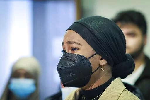 Aram Wedatalla, a Hamline University senior and the president of Muslim Student Association (MSA), cries during a news conference at CAIR-MN office, Wednesday, Jan. 11, 2023, in Minneapolis. A Hamline University lecturer showed a painting of the Prophet Muhammad and Wedatalla was one of the students in the class when the image was displayed. (Kerem Yücel/Minnesota Public Radio via AP)