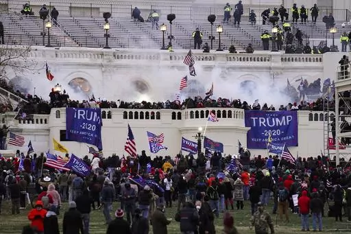 People loyal to President Donald Trump storm the U.S. Capitol on Jan. 6, 2021, in Washington. Federal authorities say a Southern California man who assaulted police with pepper spray during the storming of the U.S. Capitol was sentenced to 4 1/2 years in prison. The U.S. Department of Justice said in a statement Friday, April 28, 2023, that Jeffrey Scott Brown of Santa Ana, Calif., received a sentence of 54 months. (AP Photo/John Minchillo, File)