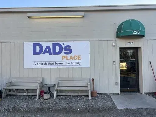 A banner announcing Dad's Place is displayed on the church's back entrance, in Bryan, Ohio, Dec. 17, 2024. (AP Photo/Patrick Aftoora-Orsagos, File)