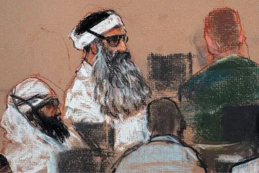 This Monday, Dec. 8, 2008 courtroom drawing by artist Janet Hamlin and reviewed by the U.S. military, shows Khalid Sheikh Mohammed, center, and co-defendant Walid Bin Attash, left, attending a pre-trial session at Guantanamo Bay Naval Base, Cuba. (AP Photo/Janet Hamlin, Pool, File)