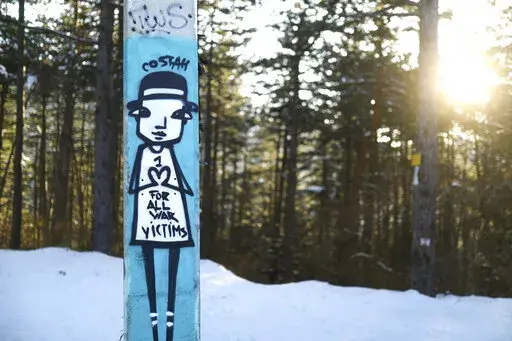 Graffiti is seen on a bob and luge track on mount Trebevic near the capital Sarajevo, Bosnia, Thursday, March 3, 2022. Survivors of the 1992-95 siege of Sarajevo cannot look away from what they say is a very similar tragedy now unfolding in Ukraine. Bosnian Serbs laid siege to Sarajevo in the early 1990s, leaving some 350,000 people trapped in the city, subjected to daily shelling and sniper attacks and cut off from regular access to electricity, food, water, medicine, and the outside world. (AP