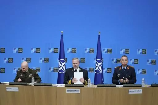Chair of the NATO Military Committee Admiral Rob Bauer, center, Supreme Allied Commander Europe, General Christopher Cavoli, left, and Supreme Allied Commander Transformation General Chris Badia prepare to address a media conference at NATO headquarters in Brussels, Thursday, Jan. 18, 2024. Ukraine is locked in an existential battle for its survival almost two years into its war with Russia and Western armies and political leaders must drastically change the way they help it fend off invading fo