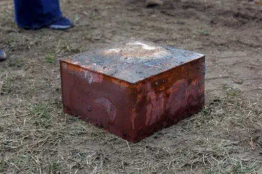 Workers recover a box believed to be the 1887 time capsule that was put under Confederate Gen. Robert E. Lee's statue pedestal in Richmond, Va., Monday, Dec. 27, 2021. Crews wrapping up the removal Monday of the giant pedestal that once held a statue of Confederate Gen. Lee found what appeared to be a second and long-sought-after time capsule, Virginia Gov. Ralph Northam said. (Eva Russo/Richmond Times-Dispatch via AP)