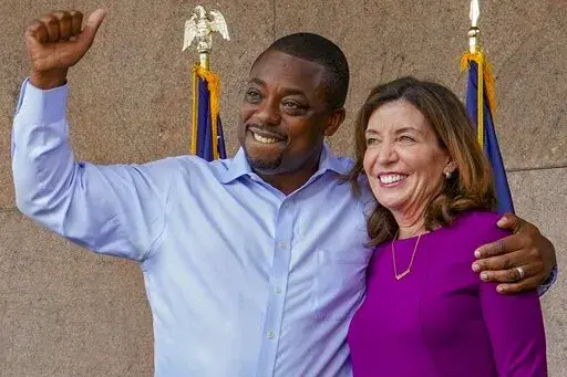 State Sen. Brian Benjamin embraces Gov. Kathy Hochul during an event in the Harlem, New York, after she made him lieutenant governor, Aug. 26, 2021. Hochul's previously smooth path to the Democratic primary hit a major bump this week when Benjamin resigned following his arrest in a federal corruption investigation. (AP Photo/Mary Altaffer, File)