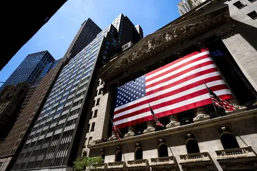 An American flag is displayed on the facade of the New York Stock Exchange on June 29, 2022, in New York. Investors had few places to hide in 2022: Stocks and bonds both nose-dived and crypto tanked. Pocketbook issues were front and center for consumers as prices for food, energy and rent jumped. (AP Photo/Julia Nikhinson, File)