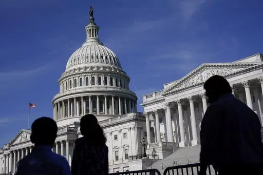 People walk outside the U.S Capitol building in Washington, June 9, 2022. President Joe Biden goes into Thursday's State of the Union address with an expanded plan to raise corporate taxes. He would use the proceeds to trim budget deficits and cut taxes for the middle class.(AP Photo/Patrick Semansky, File)