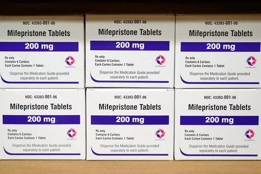 Boxes of the drug mifepristone sit on a shelf at the West Alabama Women's Center in Tuscaloosa, Ala., on March 16, 2022. Attorney generals in 20 conservative-led states warned CVS and Walgreens on Wednesday, Feb. 1, 2023, that they could face legal consequences if they sell abortion pills by mail in those states. (AP Photo/Allen G. Breed, File)