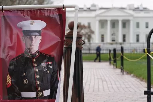 A poster photo of U.S. Marine Corps veteran and former Russian prisoner Trevor Reed stands in Lafayette Park near the White House, March 30, 2022, in Washington. Reed, a former U.S. Marine who was released from Russia in a prisoner swap last year, has been injured while fighting in Ukraine, the State Department and a person familiar with the matter said Tuesday. (AP Photo/Patrick Semansky, File)