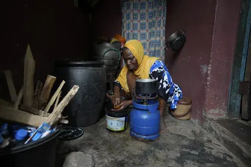 Idowu Bello, 56, prepares a meal in her kitchen in Ibadan, Nigeria, Friday, Sept. 13, 2024. (AP Photo/Sunday Alamba)