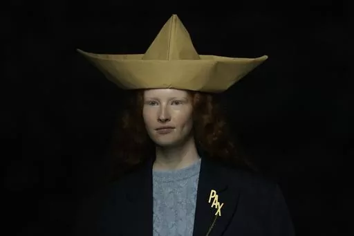 A model wears a creation as part of the Moschino women's Fall-Winter 2024-25 collection presented in Milan, northern Italy, Thursday, Feb. 22, 2024. (AP Photo/Antonio Calanni)