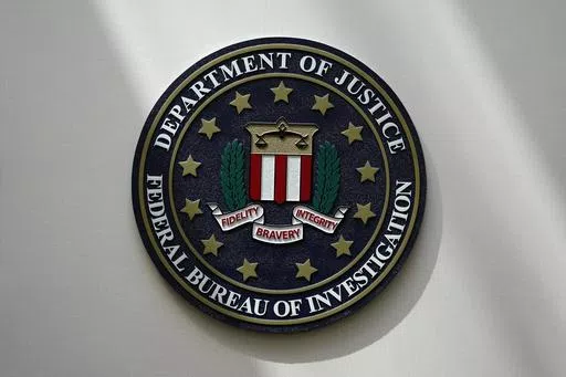 An FBI seal is seen on a wall on Aug. 10, 2022, in Omaha, Neb. The FBI says scammers stole more than $3.4 billion from older Americans last year. An FBI report released Tuesday shows a rise in losses through increasingly sophisticated tactics to trick the vulnerable into giving up their life savings. (AP Photo/Charlie Neibergall, File)