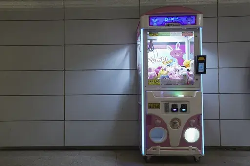 A claw machine sits inside a metro station in Rio de Janeiro, Wednesday, Aug. 28, 2024. The Rio police press office said they were carrying out search warrants targeting claw machines because they are considered games of chance and therefore illegal. (AP Photo/Hannah-Kathryn Valles)