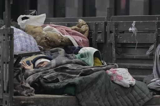 An ethnic Armenian woman from Nagorno-Karabakh rests in a truck as she arrives in Goris, Syunik region, Armenia, Wednesday, Sept. 27, 2023. Armenia finds itself facing multiple challenges after being suddenly thrust into one of the worst political crises in its decades of independence following the 1991 collapse of the Soviet Union. After Azerbaijan reclaimed control of the separatist region of Nagorno-Karabakh in a blitz offensive, tens of thousands of ethnic Armenians have flooded over its bor