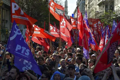 Protesters march against new economic shock measures in Buenos Aires, Argentina, Wednesday, Dec. 20, 2023. Days after taking office, Argentine President Javier Milei's government announced drastic economic measures that angered some social and labor groups, and warned it would crack down on any protests blocking streets. (AP Photo/Gustavo Garello)