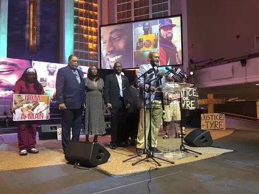 Tyre Nichols' stepfather Rodney Wells, second left, and Nichols' mother RowVaughn Wells, third left, close their eyes in prayer before a news conference about federal charges filed against five former officers in Nichols' death on Tuesday, Sept. 12, 2023, in Memphis, Tenn. Also pictured are attorney Ben Crump, fourth left, and pastor Earle Fisher, at lectern. AP Photo/Adrian Sainz)