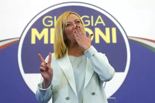 Far-Right party Brothers of Italy's leader Giorgia Meloni flashes the victory sign at her party's electoral headquarters in Rome, early Monday, Sept. 26, 2022. Italian voters rewarded Giorgia Meloni's euroskeptic party with neo-fascist roots, propelling the country toward what likely would be its first far-right-led government since World War II, based on partial results Monday from the election for Parliament. (AP Photo/Gregorio Borgia)