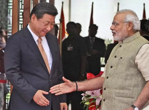 FILE- Indian Prime Minister Narendra Modi welcomes Chinese President Xi Jinping upon the latter's arrival at a hotel in Ahmadabad, India, Wednesday, Sept. 17, 2014. India is protesting a new Chinese map that lays claim to India’s territory ahead of next week's Group of 20 summit in New Delhi, a foreign ministry official said on Tuesday, Aug. 29, 2023, exacerbating tensions during a three-year military standoff between the two nations. The timing of the protest is key, as Chinese President Xi J