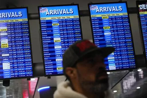 Flight status boards show delayed and cancelled flights at Harry Reid International Airport, Wednesday, Jan. 11, 2023, in Las Vegas. Delays and cancellations among flights across the United States were minimal on Thursday, a day after a system that offers safety information to pilots failed, grounding some planes for hours. (AP Photo/John Locher)