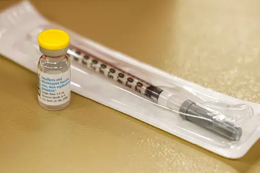 A vial containing the monkeypox vaccine and a syringe is set on the table at a vaccination clinic run by the Mecklenburg County Public Health Department in Charlotte, N.C., Saturday, Aug. 20, 2022. In the wake of a study released on Thursday, Sept. 8, 2022, U.S. officials are considering broadening recommendations for who gets vaccinated against monkeypox, possibly to include many men being treated for HIV or those who recently had other sexually transmitted infections. (AP Photo/Nell Redmond, F