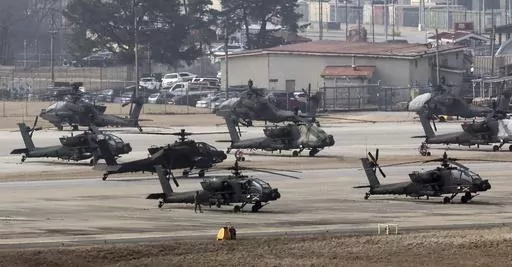 U.S. Army Apache helicopters take off at Camp Humphreys in Pyeongtaek, South Korea, Monday, March 4, 2024. North Korea called the ongoing South Korean-U.S. military drills a plot to invade the country, as it threatened Tuesday to take unspecified "responsible" military steps in response. (Kwon June-woo/Yonhap via AP)