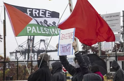 Hundreds of pro-Palestinian protesters gather at the Port of Tacoma at Terminal 7 to block what they believe to be a military ship bound for Israel, Monday, Nov. 6, 2023. (Ellen M. Banner/The Seattle Times via AP)