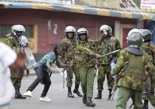 Police clash with a man during a protest by supporters of Kenya's opposition leader Raila Odinga over the high cost of living and alleged stolen presidential vote, in Nairobi, on March 20, 2023. The United States is praising Kenya's interest in leading a multinational force in Haiti. But weeks ago, the U.S. openly warned Kenyan police officers against violent abuses. Now 1,000 of those police officers might head to Haiti to take on gang warfare. (AP Photo/Brian Inganga, File)