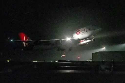 A repurposed Virgin Atlantic Boeing 747 aircraft, named Cosmic Girl, carrying Virgin Orbit's LauncherOne rocket, takes off from Spaceport Cornwall at Cornwall Airport, Newquay, England, on Jan. 9, 2023. Virgin Orbit said Thursday March 16, 2023 it is pausing all operations amid reports that the company is furloughing almost all its staff as part of a bid to seek a funding lifeline. (Ben Birchall/PA via AP)