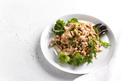 This image released by Milk Street shows a recipe for Chicken and Bean Salad with Pepper Jelly Vinaigrette. (Milk Street via AP)
