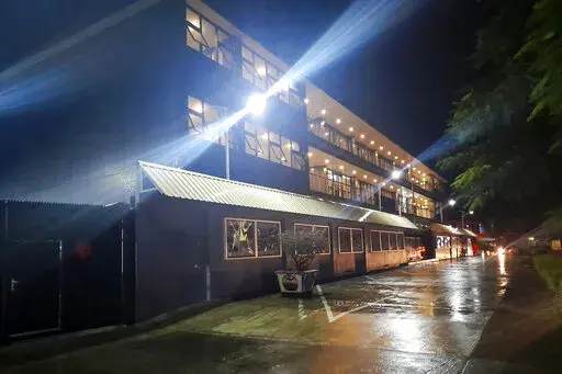 Floodlights illuminate the Chinese Embassy after a rain in Honiara, Solomon Islands, April 1, 2022. A security alliance between China and the Solomon Islands has sent shudders throughout the South Pacific, with many worried it could set off a large-scale military buildup or that Western animosity to the deal could play into China’s hands. (AP Photo/Charley Piringi, File)