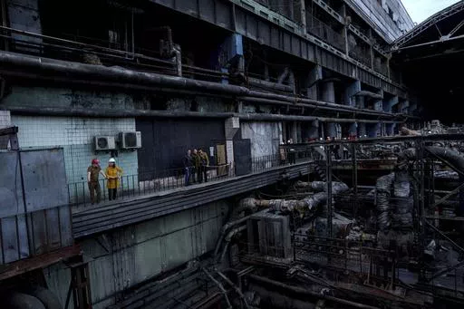 German's Foreign Minister Annalena Baerbock speaks to Ukrainian Energy Minister Herman Halushchenko during official visit to a thermal power plant which was destroyed by a Russian rocket attack in Ukraine, Tuesday, May 21, 2024. (AP Photo/Evgeniy Maloletka)