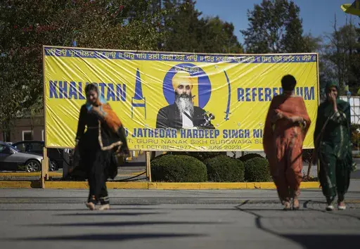 A banner that shows the late Sikh separatist leader Hardeep Singh Nijjar is displayed outside the Guru Nanak Sikh Gurdwara Sahib in Surrey, British Columbia, Sept. 18, 2023, where he was gunned down in his vehicle while leaving the temple parking lot. Canadian police said Friday, May 3, 2024, that they have made three arrests in the June slaying. (Darryl Dyck/The Canadian Press via AP, File)