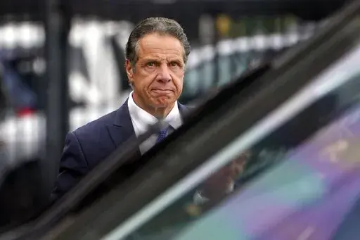 FILE -  New York Gov. Andrew Cuomo prepares to board a helicopter after announcing his resignation on Aug. 10, 2021, in New York. Westchester County District Attorney Mimi Rocah announced Tuesday, Dec. 28, 2021, she couldn't pursue charges under New York law against Cuomo stemming from allegations from two women that he planted unwanted kisses on their cheeks. (AP Photo/Seth Wenig, File)