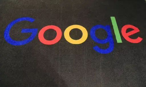 The logo of Google is displayed on a carpet at the entrance hall of Google France in Paris, Monday, Nov. 18, 2019. European Union officials are nearing agreement on a set of new rules aimed at protecting internet users by forcing big tech companies like Google and Facebook to step up their efforts to curb the spread of illegal content. EU officials were negotiating over the final details of the new legislation, dubbed the Digital Services Act, on Friday, April 22, 2022. (AP Photo/Michel Euler, F