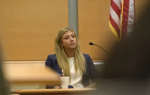 Brittany Paz, a lawyer hired by Alex Jones to testify about his companies, is questioned by plaintiff's attorney Chris Mattei during Jones' Sandy Hook defamation damages trial in Superior Court in Waterbury, Conn., on Thursday, Sept. 15, 2022. (H John Voorhees III/Hearst Connecticut Media via AP, Pool)