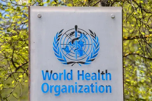 The logo and building of the World Health Organization (WHO) headquarters in Geneva, Switzerland, 15 April 2020. The World Health Organization says on Thursday, Jan. 6, 2022 a record 9.5 million cases of COVID-19 were tallied around the world over the last week, noting a 71% surge in the weekly count of infections amounting to a “tsunami” as the new omicron variant sweeps worldwide. But there was a decrease in the number of new deaths recorded. (Martial Trezzini/Keystone via AP, file)