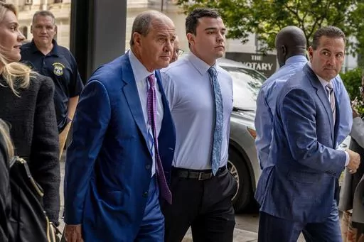 Philadelphia police Officer Mark Dial, center, arrives at the Juanita Kidd Stout Center for Criminal Justice in Philadelphia, Sept. 19, 2023, with attorneys Brian McMonagle, left and Fortunato Perri, right, for a bail hearing. Lawyers for Dial, who shot and killed a driver, will press to have the murder charges lodged against him dismissed when the jailed officer appears in court, Tuesday, Sept. 26. (Tom Gralish/The Philadelphia Inquirer via AP, File)