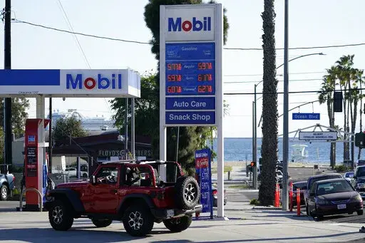 Gas prices are displayed at a gas station Friday, March 11, 2022, in Long Beach, Calif.  Rebates or cash payments are being proposed in California, New Mexico, Pennsylvania and elsewhere as states are flush with cash and Americans are facing the highest inflation in four decades. (AP Photo/Ashley Landis, File)