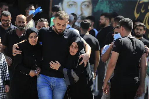 People react during the funeral procession of their relatives, who were killed in Monday's Israeli airstrikes, in the southern village of Saksakieh, Lebanon, Tuesday, Sept. 24, 2024. (AP Photo/Mohammed Zaatari, File)