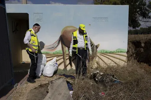 Volunteers from the ZAKA rescue service remove blood stains from a public bomb shelter on a road near the Israeli-Gaza border in the aftermath of the Oct. 7 Hamas attack, Nov. 20, 2023. Some allege the accounts of sexual assault were purposely concocted. Zaka officials and others dispute that. Regardless, AP’s examination of Zaka’s handling of the now debunked stories shows how information can be clouded and distorted in the chaos of the conflict. (AP Photo/Ohad Zwigenberg, File)