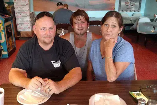 This August 2017 family photo shows Austin Hunter Turner with his mother, Karen Goodwin, and her husband, Brian, at a pizza restaurant in Bristol, Tenn., a week before Hunter's death. It is the last photo of them together. (Family photo via AP, File)