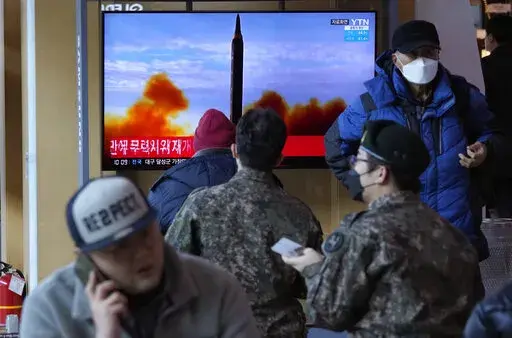 People watch a TV showing a file image of North Korea's missile launch during a news program, at the Seoul Railway Station in Seoul, South Korea, Sunday, Feb. 27, 2022. North Korea on Sunday launched a suspected ballistic missile into the sea, South Korean and Japanese officials said, in an apparent resumption of its weapons tests following the end of the Winter Olympics in China, the North's last major ally and economic pipeline. (AP Photo/Ahn Young-joon)