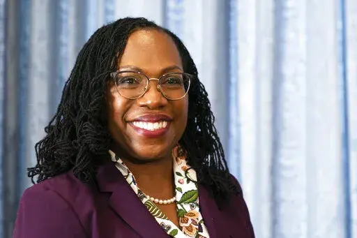 Supreme Court nominee Judge Ketanji Brown Jackson glances at members of the media during her meeting with Sen Mark Warner, D-Va., on Capitol Hill, Monday, April 4, 2022, in Washington. (AP Photo/Manuel Balce Ceneta)