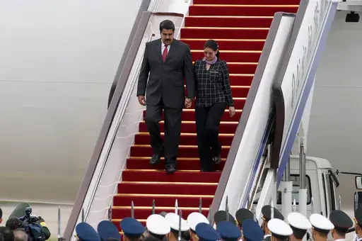 Venezuela's President Nicolas Maduro, left, and first lady Cilia Flores arrive at Beijing Capital International Airport in Beijing, China, Sept. 1, 2015. (AP Photo/Ng Han Guan, File)