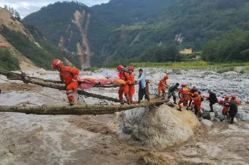 In this photo released by Xinhua News Agency, rescuers transfer survivors across a river following an earthquake in Moxi Town of Luding County, southwest China's Sichuan Province Monday, Sept. 5, 2022. Dozens people were reported killed and missing in an earthquake that shook China's southwestern province of Sichuan on Monday, triggering landslides and shaking buildings in the provincial capital of Chengdu, whose 21 million residents are already under a COVID-19 lockdown. (Cheng Xueli/Xinhua via