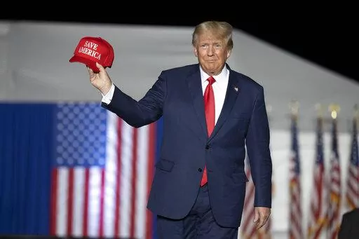 Former President Donald Trump makes his entrance at a rally at the Minden Tahoe Airport in Minden, Nev.,  Oct. 8, 2022. Trump angrily lashed out Wednesday, Oct. 12, calling the nation's legal system a “broken disgrace" after a judge ruled he must answer questions under oath next week in a defamation lawsuit lodged by a writer who says he raped her in the mid-1990s. (AP Photo/José Luis Villegas, Pool, File)