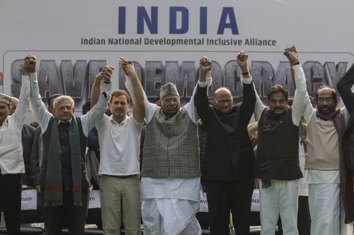 FILE- Leaders from the opposition INDIA alliance raise their hands together in a show of unity during a protest rally against the suspension of more than 140 lawmakers from the parliament, in New Delhi, India, Dec. 22, 2023. Last year more than two dozen opposition parties in India came together to take on Narendra Modi, one of the country's most popular prime ministers in generations. But the broad alliance, beset with ideological differences and personality clashes, is cracking at a crucial ti