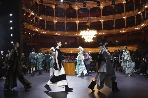 Models wear creations as part of the Issey Miyake Fall/Winter 2023-2024 ready-to-wear collection presented Friday, March 3, 2023 in Paris. (Vianney Le Caer/Invision/AP)