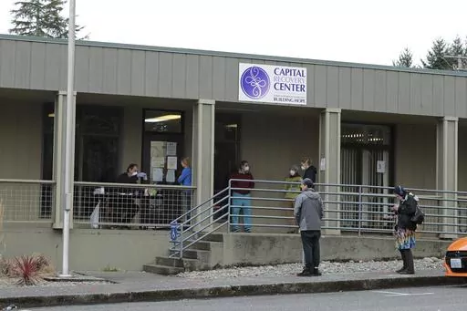 Patients line up to pick up medication for opioid addiction at a clinic in Olympia, Wash., on March 27, 2020. (AP Photo/Ted S. Warren, File)