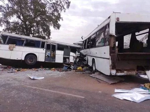 Two damaged buses are pictured after they collided on a road in Gniby, Senegal, Sunday Jan. 8, 2023. At least 40 people were killed and dozens injured in this bus crash in central Senegal, the country's president Macky Sall said Sunday. (Elimane Fall via AP)